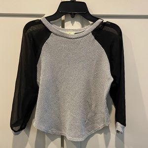 Girls gray top with black mesh sleeves.